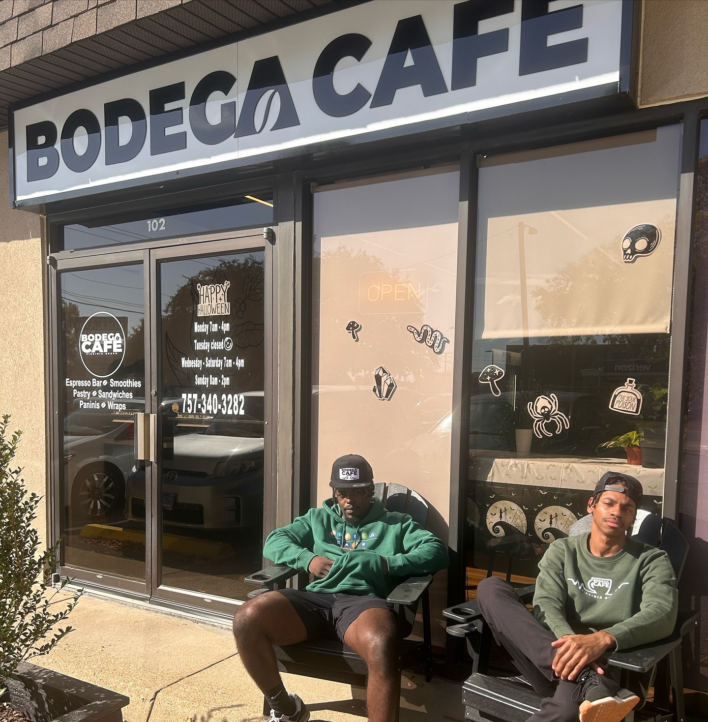 Storefront window with Bodega Café decals at Halloween
