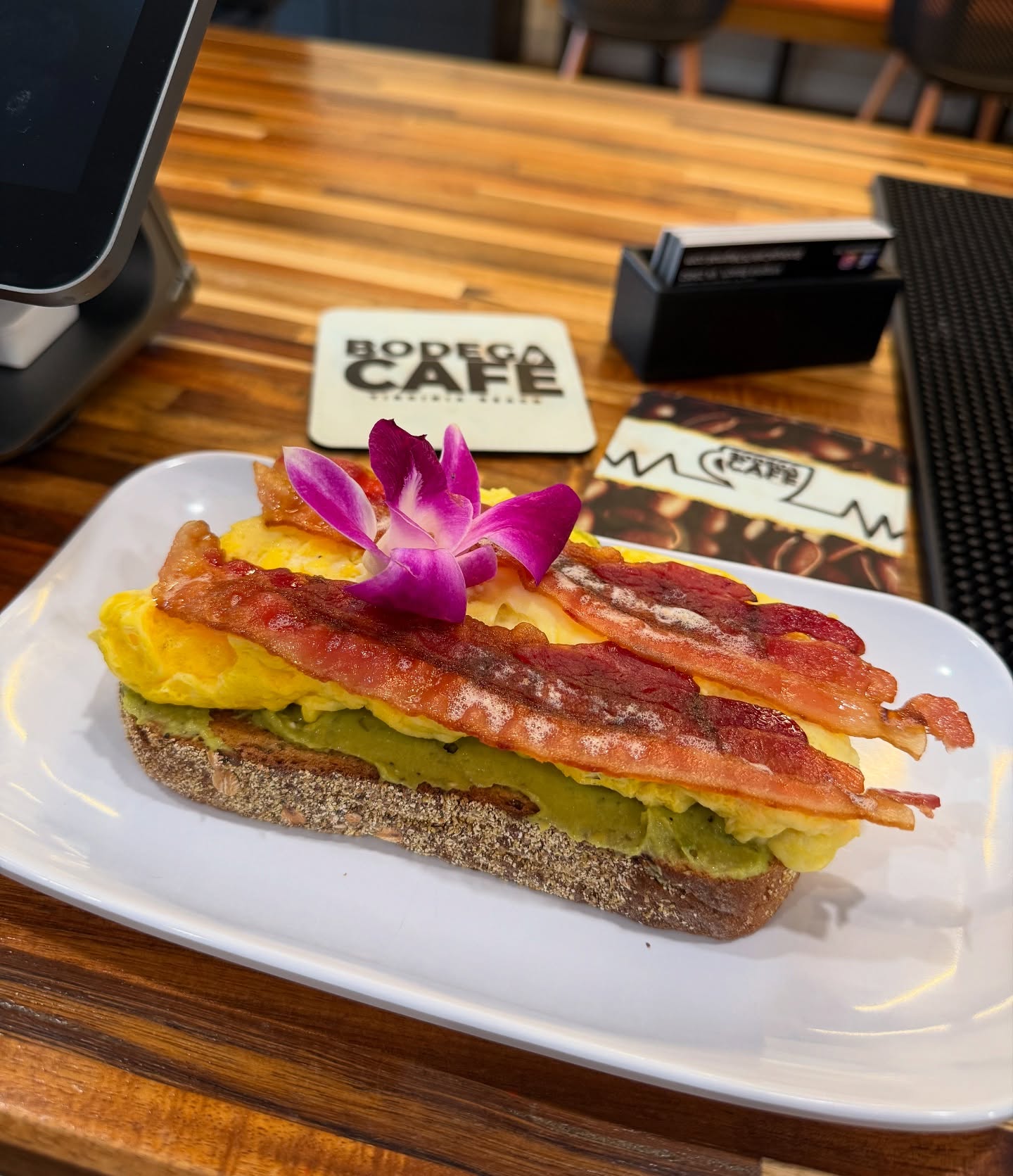 Avocado toast with eggs and bacon on a multigrain slice